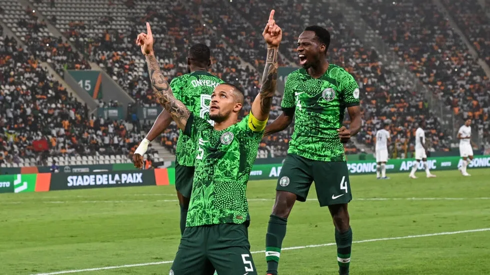 Image de Football. La CAN 2023 a vu émerger le Nigeria en tant que forteresse défensive, avec en première ligne le capitaine indomptable William Troost-Ekong. À la veille de la finale contre les Éléphants, plongeons dans le parcours exceptionnel de ce colosse au destin marqué par la loyauté envers son pays et une contribution majeure à la protection des cages des Super Eagles. La Fondation de la Solidité Défensive Le Nigeria, porté par l'éclat de Victor Osimhen en attaque, doit également son succès à la muraille défensive incarnée par Troost-Ekong. Malgré une attaque dynamique, les Super Eagles ont brillé par leur solidité, encaissant seulement deux buts avant d'atteindre la finale. Un exploit souvent sous-estimé mais essentiel pour le capitaine nigérian. Un Parcours Semé d'Expériences Européennes Originaire des Pays-Bas, Troost-Ekong a tracé son chemin à travers les clubs européens, portant successivement les couleurs de clubs prestigieux. Son choix de représenter le Nigeria a été marqué par un appel du légendaire Stephen Keshi, soulignant la profondeur de ses racines nigérianes malgré des opportunités de jouer pour les Oranje. Le Leader Tactique : Gernot Rohr Témoigne Gernot Rohr, ancien sélectionneur du Nigeria, souligne l'impact tactique de Troost-Ekong. En plus de ses qualités physiques impressionnantes, le défenseur se distingue par son intelligence sur le terrain. Rohr révèle comment Troost-Ekong a été son premier choix en tant que capitaine, un rôle qu'il exerce avec brio, orchestrant la défense et motivant ses coéquipiers. Engagements Extra-Sportifs Au-delà du terrain, Troost-Ekong se distingue par son engagement pour l'écologie. En arborant des crampons recyclables à base de bambou et de canne à sucre, il envoie un message fort sur la responsabilité environnementale des sportifs. Un geste qui témoigne de sa vision à long terme, pensant aux générations futures. Un Attaquant dans la Peau d'un Défenseur Le match contre l'Afrique du Sud en demi-finale a été l'occasion pour Troost-Ekong d'inscrire son quatrième but en Coupe d'Afrique des nations, égalant ainsi le record de Stephen Keshi. Une performance remarquable pour un défenseur central, soulignant sa polyvalence et sa contribution offensive. La Finale Imminente et l'Héritage en Jeu À la veille de la confrontation avec les Éléphants en finale, Troost-Ekong demeure humble malgré son rôle crucial. En ayant déjà battu les Ivoiriens en phase de poules, il sait que la tâche à venir sera immense. Le capitaine nigérian parle de cette édition comme peut-être la meilleure équipe qu'il ait connue, honorant les légendes qui ont porté le maillot des Super Eagles. La trajectoire de Troost-Ekong à la CAN 2023 illustre bien plus qu'un parcours sportif exceptionnel. C'est une histoire de loyauté envers la patrie, de leadership tactique, et d'engagement envers des causes plus vastes que le football. Alors que la finale approche, une question plane : Troost-Ekong écrira-t-il un nouveau chapitre de gloire pour les Super Eagles et consolidera-t-il son statut d'icône dans l'histoire du football nigérian ?