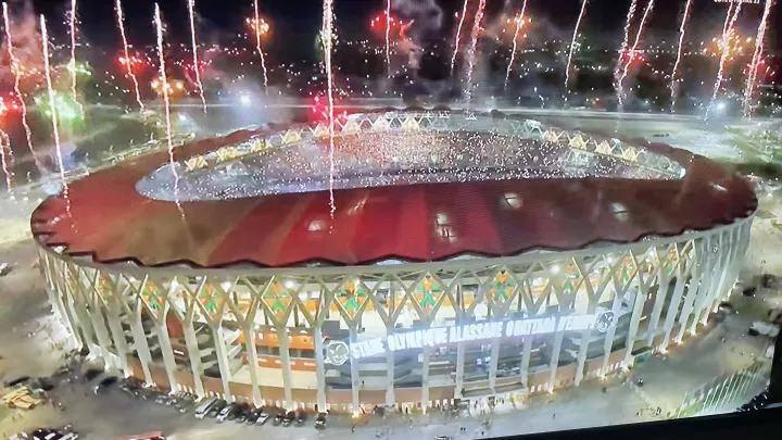 Image de Musique/Radio. La soirée de clôture à la Coupe d'Afrique des Nations 2023 s'est avérée mémorable, ponctuée par l'hymne 'Coup du Marteau' et des performances captivantes des artistes en vogue. Un Couronnement Musical Inoubliable L'ultime chapitre de la CAN 2023 s'est écrit en musique, avec l'hymne non officiel "Coup du Marteau" résonnant dans l'enceinte vibrante du stade Alassane Ouattara d'Ebimpé. Une clôture en apothéose orchestrée par des talents émergents tels que Tamsir, Tazboy, Ste Milano, et la team Paiya, qui ont enflammé le public avec leur titre culte, devenu le leitmotiv de cette compétition. Sous une lumière tamisée, créée par les torches des téléphones allumées, le public s'est unifié dans un chant puissant, adoptant spontanément cet hymne devenu incontournable. Pour ces jeunes artistes, c'était un rêve devenu réalité, une ascension fulgurante qu'ils n'avaient pas anticipée. L'Éclectisme des Performances La soirée de clôture n'était pas seulement marquée par le "Coup du Marteau". Roseline Layo a envoûté l'auditoire avec "Môgôfariman", tandis que Serges Beynaud a enflammé la scène avec son incontournable "C'est Dosé". Didi B, avec "En Haut" et "Y’a Dieu Dedans", a également brillé aux côtés des artistes du moment, fortement plébiscités par la jeunesse. La méga-star Alpha Blondy, en tant que figure de proue de la scène musicale ivoirienne, a ouvert magistralement ce spectacle de clôture. Sa présence a ajouté une touche de prestige à un événement déjà mémorable, soulignant ainsi la diversité musicale de la Côte d'Ivoire. Un Au Revoir Enchanté La cérémonie de clôture s'est achevée sur une note majestueuse avec l'interprétation de l'hymne officiel par l'orchestre philharmonique des enfants, accompagnée d'un spectacle de feux d'artifice éblouissant. Cet instant magique a été le prélude à un tout autre spectacle : le retour imminent des équipes sur le terrain pour un dernier face-à-face intense. Au-delà de la conclusion époustouflante de la CAN 2023, une question demeure en suspens : quel sera le prochain chapitre de cette aventure footballistique et musicale en constante évolution ? Les échos du "Coup du Marteau" continueront-ils de résonner au-delà des stades, transcendant les frontières et inspirant de nouveaux talents ? Seul l'avenir nous le dira.