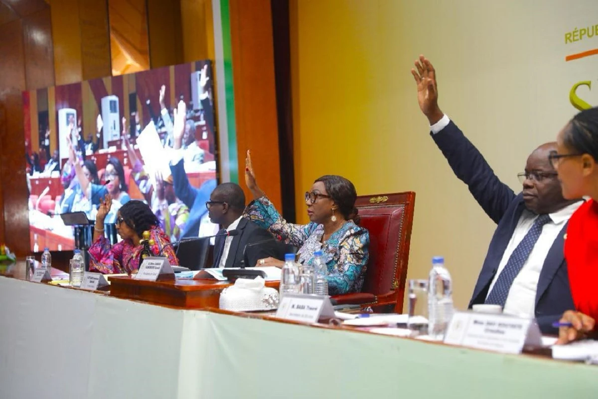 Image de Politique. Dans un contexte de vigilance accrue, le Sénat de Côte d'Ivoire, sous la houlette de son Excellence Mme Kandia Kamissoko Camara, s'est réuni en session extraordinaire à la Fondation Félix Houphouët-Boigny pour la recherche de la paix à Yamoussoukro. Le mardi 11 juin 2024, sur instruction du Premier Ministre Robert Beugré Mambé, neuf projets de loi vitaux ont été examinés et adoptés à l'unanimité, marquant une étape cruciale dans la lutte contre le blanchiment de capitaux, le financement du terrorisme, et d’autres menaces sécuritaires majeures. Un contexte d'urgence législative La séance plénière du Sénat s'est tenue dans un climat d'urgence, dictée par la nécessité impérieuse de renforcer le cadre législatif en réponse aux recommandations du Groupe d'Action Financière. Ces mesures législatives visent à colmater les brèches exploitées par les réseaux criminels et terroristes, en renforçant les dispositifs de contrôle et de répression déjà en place. Les neuf projets de loi abordés couvrent un éventail de mesures, allant de la révision du Code Pénal et du Code de Procédure Pénale à la création de registres pour les bénéficiaires effectifs des entités juridiques. Les modifications apportées visent à augmenter l'efficacité des enquêtes et des poursuites judiciaires, notamment en matière de terrorisme et de criminalité économique. Un focus particulier a été mis sur la protection environnementale, avec des lois dédiées à la gestion de la faune et à la protection des espèces en danger. La procédure d'urgence mise en œuvre pour ces projets de loi témoigne de la réactivité du Sénat face aux enjeux sécuritaires actuels. Adoptés après un examen minutieux en commission du 7 au 10 juin, ces textes ont été délibérés en plénière dans un délai exceptionnellement court, illustrant l'efficacité du processus législatif en situation d'urgence. Réactions et implications politiques La décision d'adopter ces lois en urgence a suscité des réactions diverses au sein de la classe politique et des experts en sécurité. "Ces mesures renforcent indubitablement notre arsenal législatif dans des domaines cruciaux pour la sécurité nationale et la stabilité économique," a affirmé un expert en sécurité lors d'un entretien. Toutefois, certains critiques arguent que la rapidité de ce processus pourrait compromettre la minutie nécessaire à l'élaboration de lois d'une telle envergure. Avec l'adoption de ces lois, la Côte d'Ivoire se positionne comme un acteur proactif dans la lutte internationale contre les menaces transnationales. Ce renforcement législatif ouvre également des perspectives pour des collaborations internationales plus étroites, notamment en termes d'échanges d'informations et de pratiques judiciaires. En adoptant ces neuf projets de loi en un temps record, le Sénat de Côte d'Ivoire démontre sa capacité à répondre avec agilité et détermination aux exigences d'un environnement sécuritaire en mutation. Cet effort législatif, bien que rapide, pose les fondations pour une protection renforcée de la société ivoirienne contre des menaces de plus en plus complexes. Quelles seront les retombées à long terme de ces nouvelles dispositions pour la stabilité régionale de l'Afrique de l'Ouest?